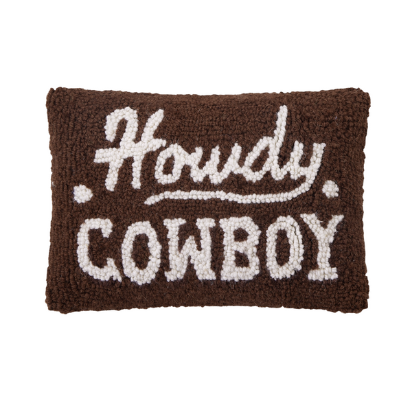 Decorative pillow with 'Howdy Cowboy' text on a brown background